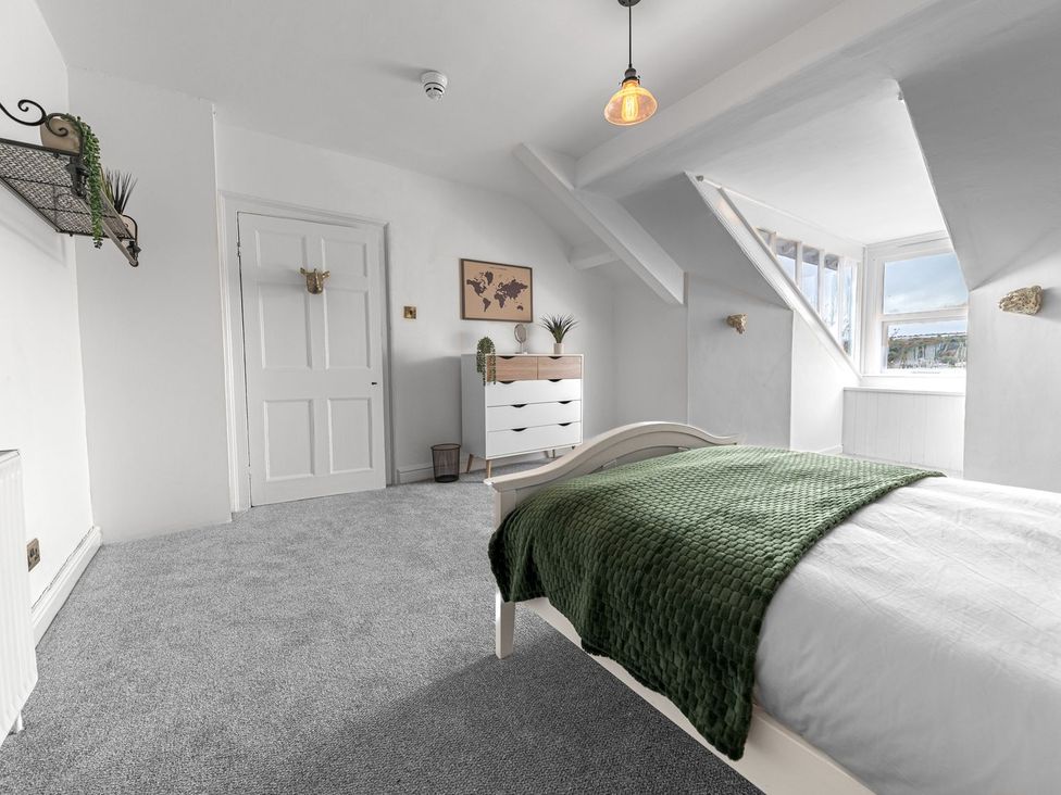 A bedroom with a bed and chest of drawers at 8 Corkickle Whitehaven