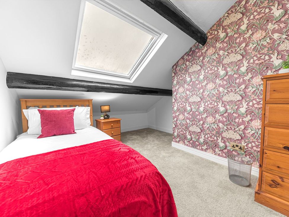 A bedroom with a bed and nightstand at 8 Corkickle in Whitehaven