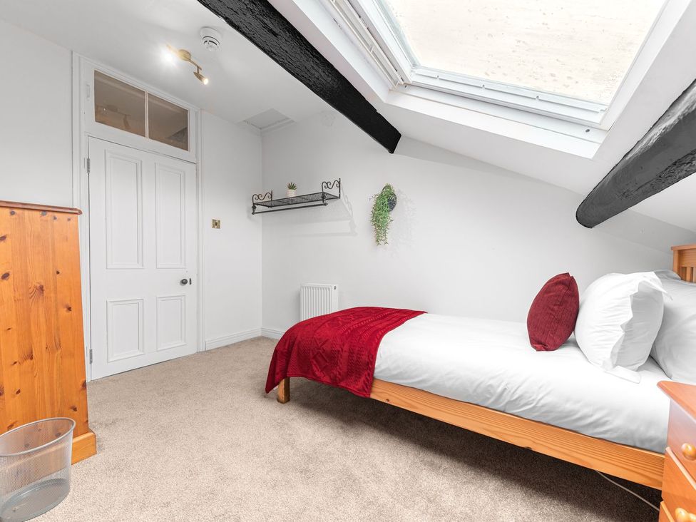 A bedroom with a bed and shelf at 8 Corkickle Whitehaven