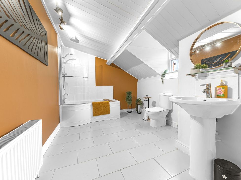 A bathroom with a bathtub, toilet, and sink at 8 Corkickle in Whitehaven