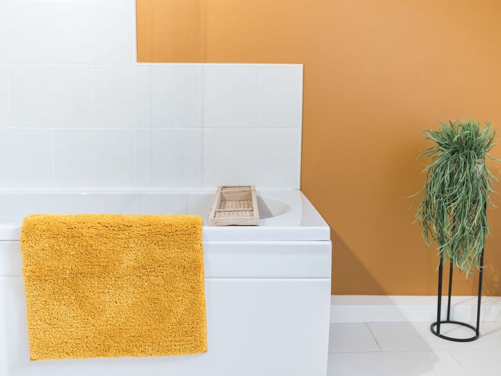A bathroom with a bathtub and a towel hanging at 8 Corkickle Whitehaven