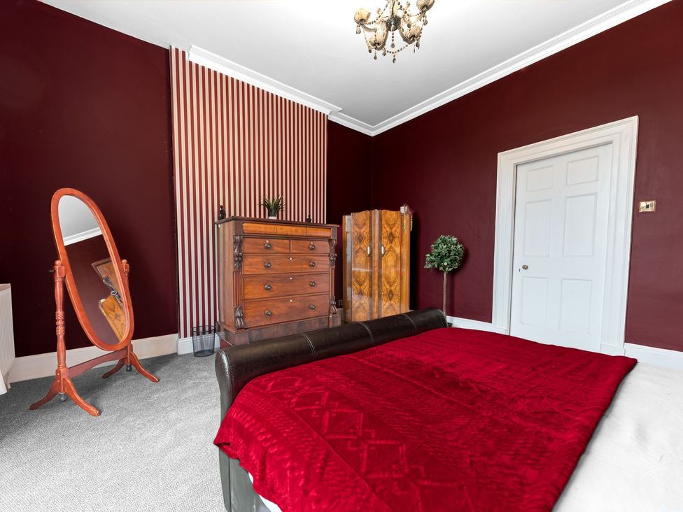A bedroom with furniture including a bed and chest of drawers at 8 Corkickle, Whitehaven