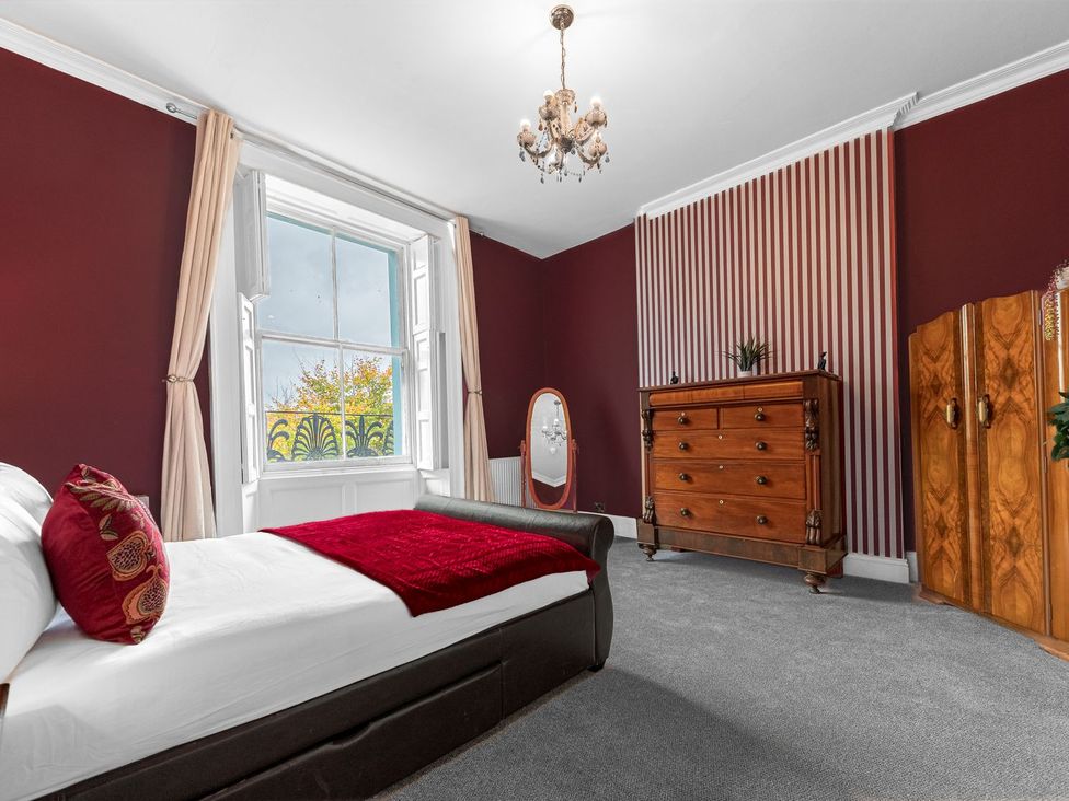A bedroom with a bed and furniture at 8 Corkickle in Whitehaven