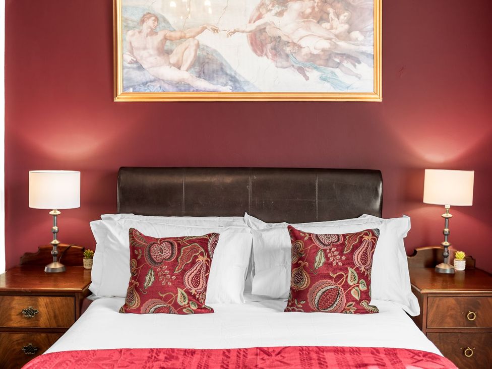 A bedroom with a bed and nightstands at 8 Corkickle Whitehaven