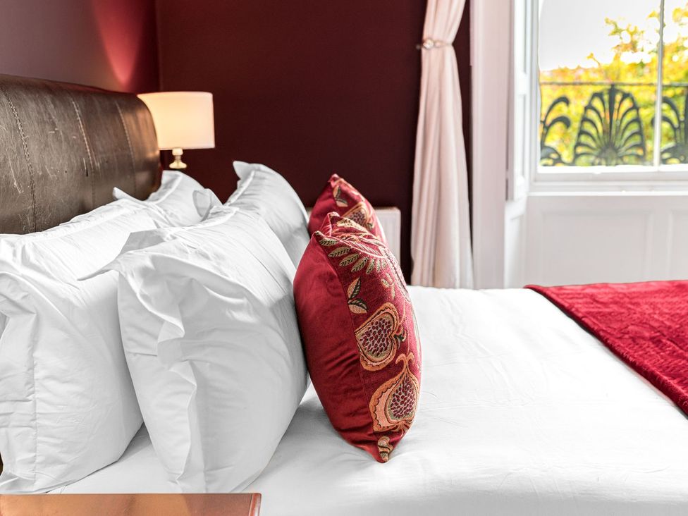 A bedroom with pillows and a lamp at 8 Corkickle Whitehaven
