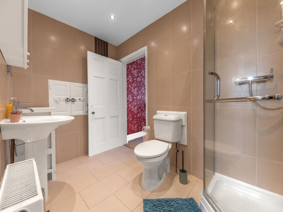 A bathroom with a sink, toilet, and shower at 8 Corkickle Whitehaven