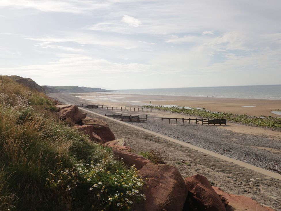 A beach with cliffs and wooden posts at 8 Corkickle Whitehaven