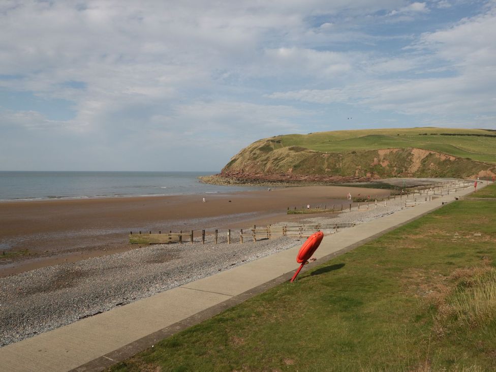 A beach with a pathway and lifebuoy at 8 Corkickle, Whitehaven