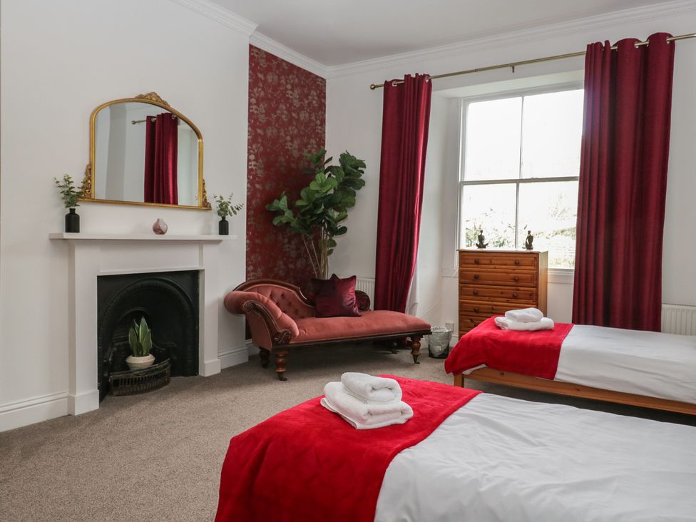 A bedroom with two beds and a sofa at 8 Corkickle Whitehaven