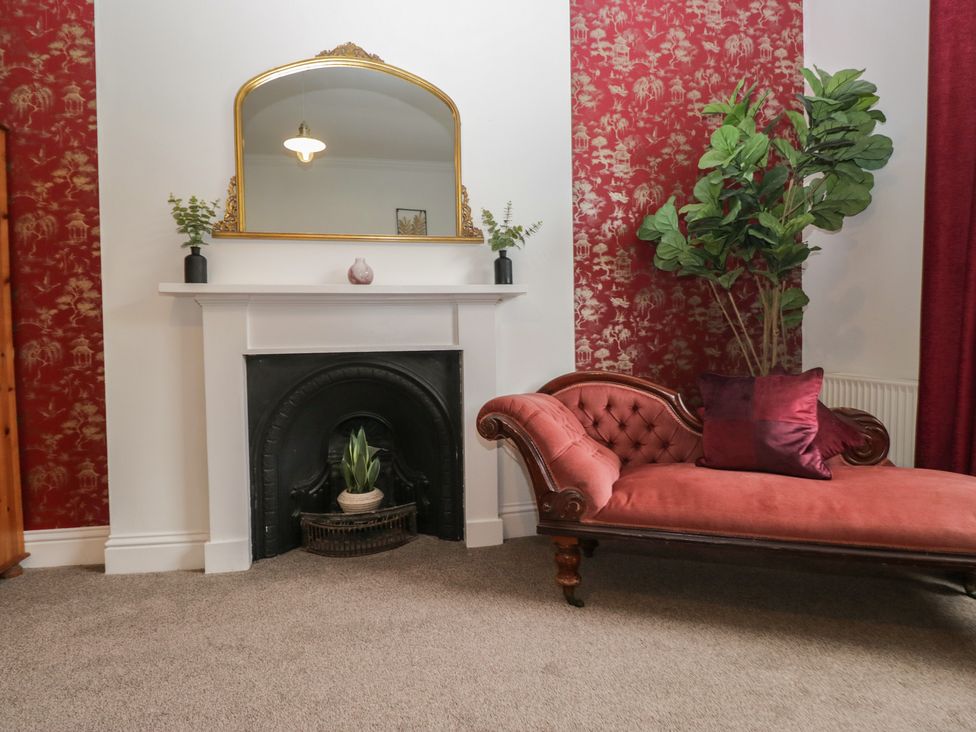 A living room with a sofa and a fireplace at 8 Corkickle Whitehaven