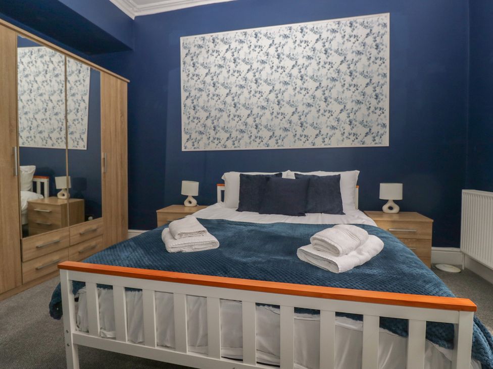 A bedroom with a bed and wardrobe at 8 Corkickle Whitehaven