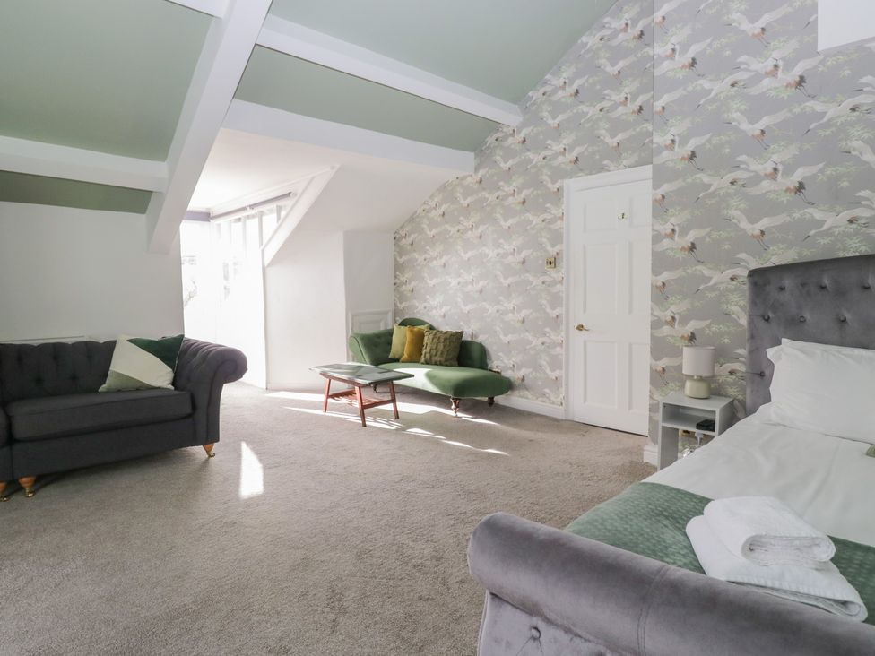 A bedroom with a sofa and coffee table at 8 Corkickle in Whitehaven