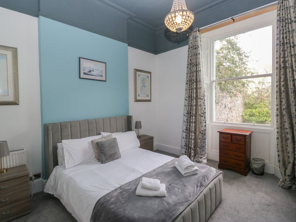 A bedroom with a bed and nightstand at 8 Corkickle in Whitehaven