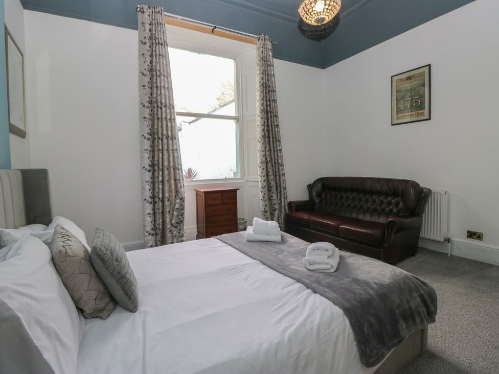 A bedroom with a bed and a sofa at 8 Corkickle Whitehaven