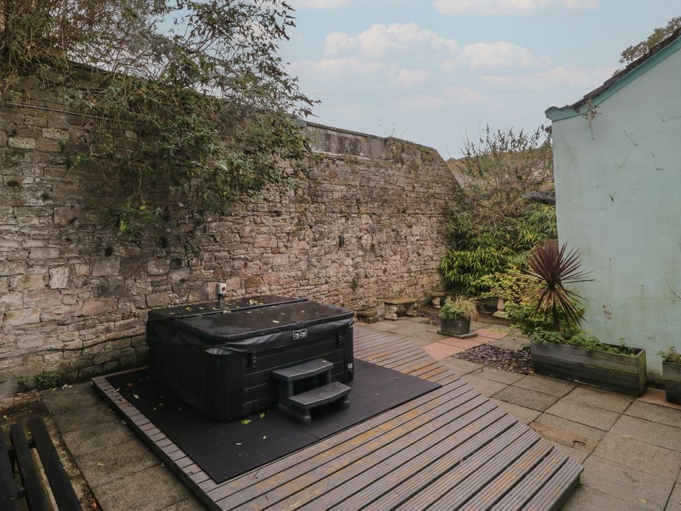 A garden with a hot tub on decking at 8 Corkickle Whitehaven