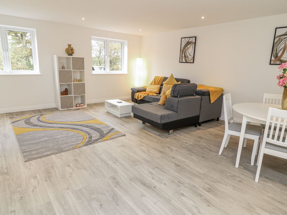 A living room with a sofa and dining table at Station House Scredington near Osbournby