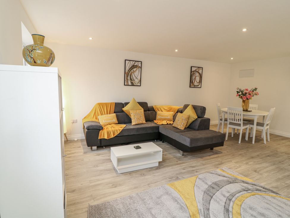 A living room with a sofa and dining table at Station House in Scredington near Osbournby