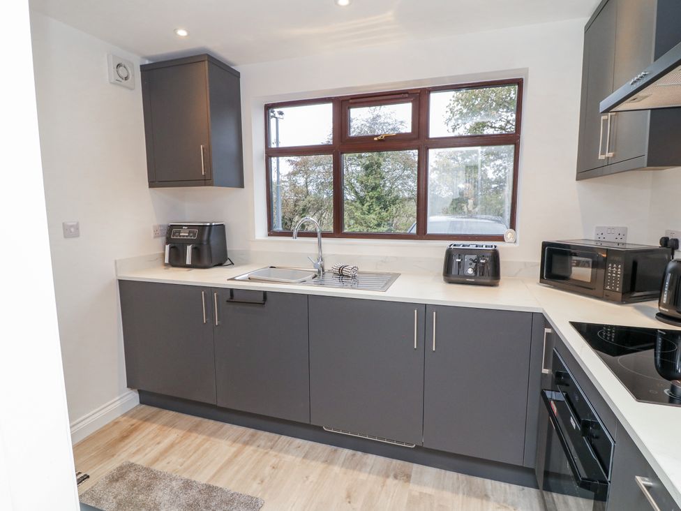 A kitchen with a sink and appliances at Station House in Scredington near Osbournby