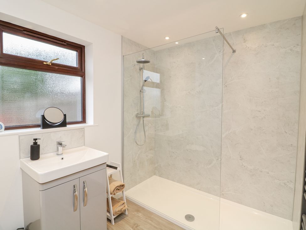 A bathroom featuring a shower and sink at Station House in Scredington near Osbournby