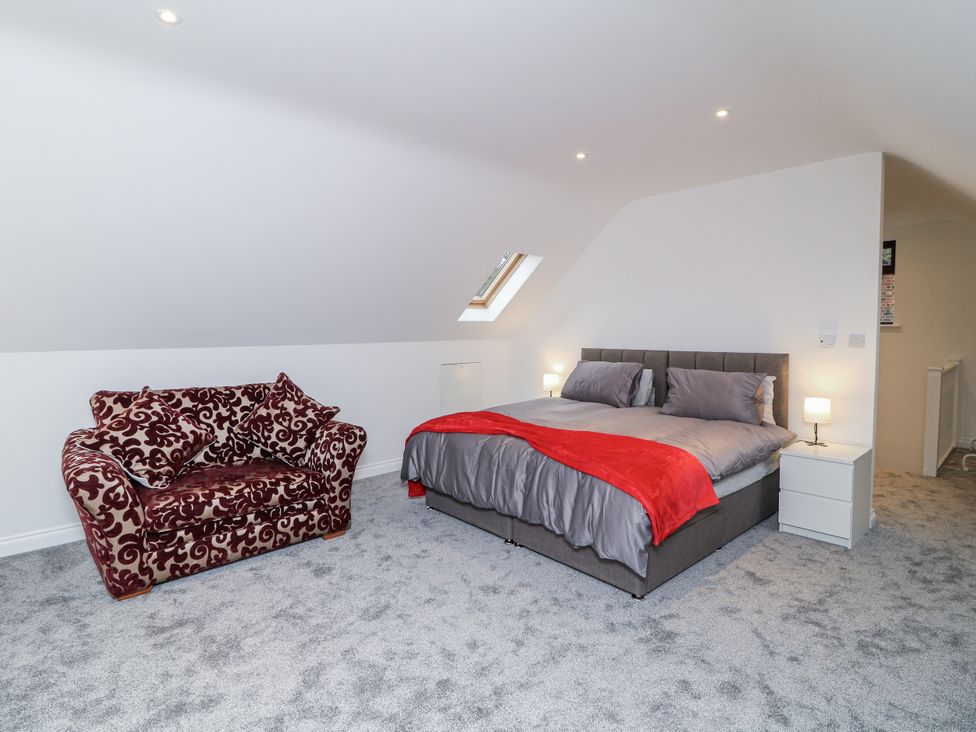 A bedroom with a bed and a sofa at Station House in Scredington near Osbournby