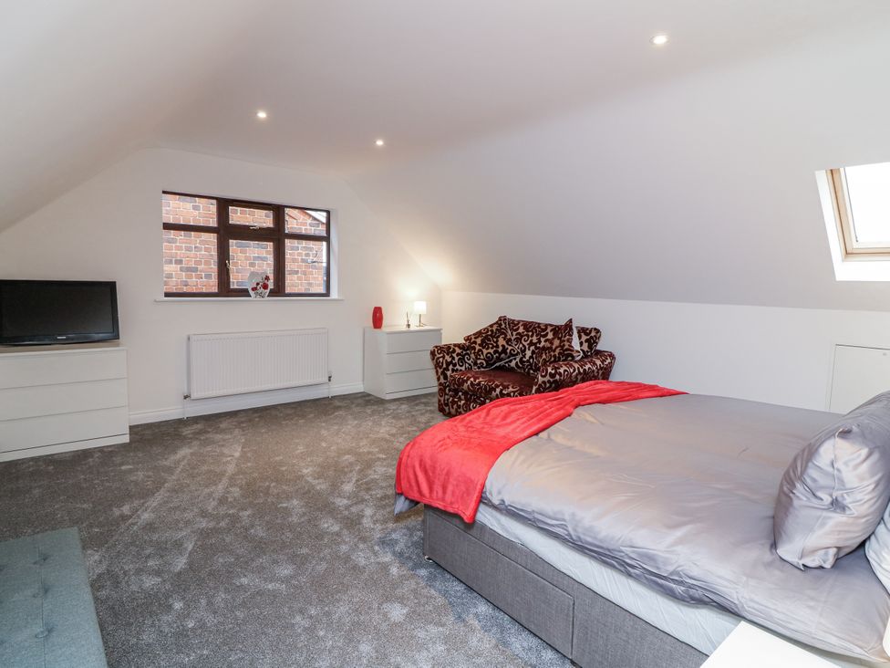 A bedroom with a bed and sofa at Station House in Scredington near Osbournby