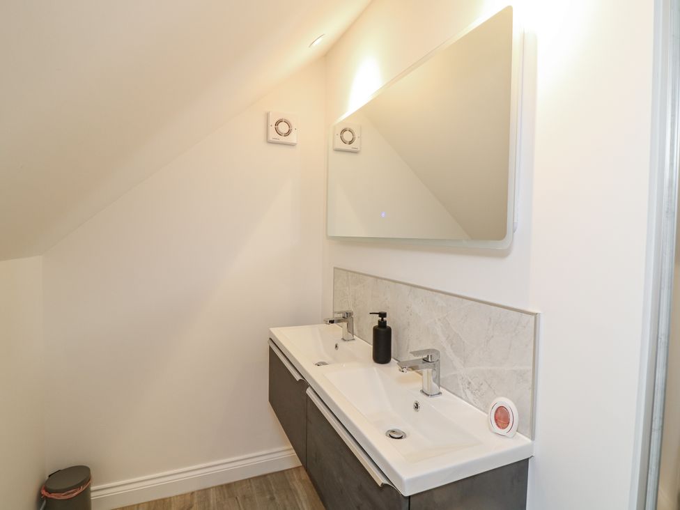 A bathroom with a sink and mirror at Station House in Scredington near Osbournby
