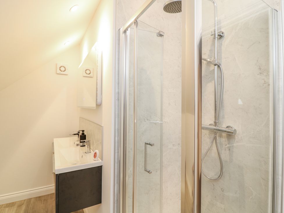 A bathroom with a shower and a sink at Station House in Scredington near Osbournby