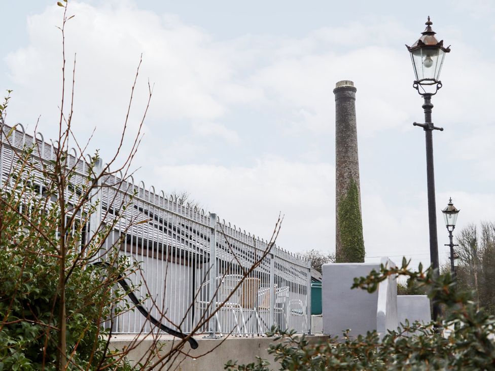 An outdoor scene with a chimney and a lamp post at 23 Goonbarrow Meadow