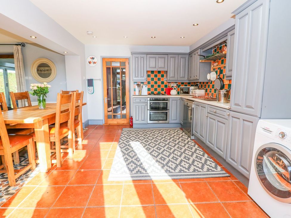 A kitchen with dining table and chairs at Peters Lea Bakewell