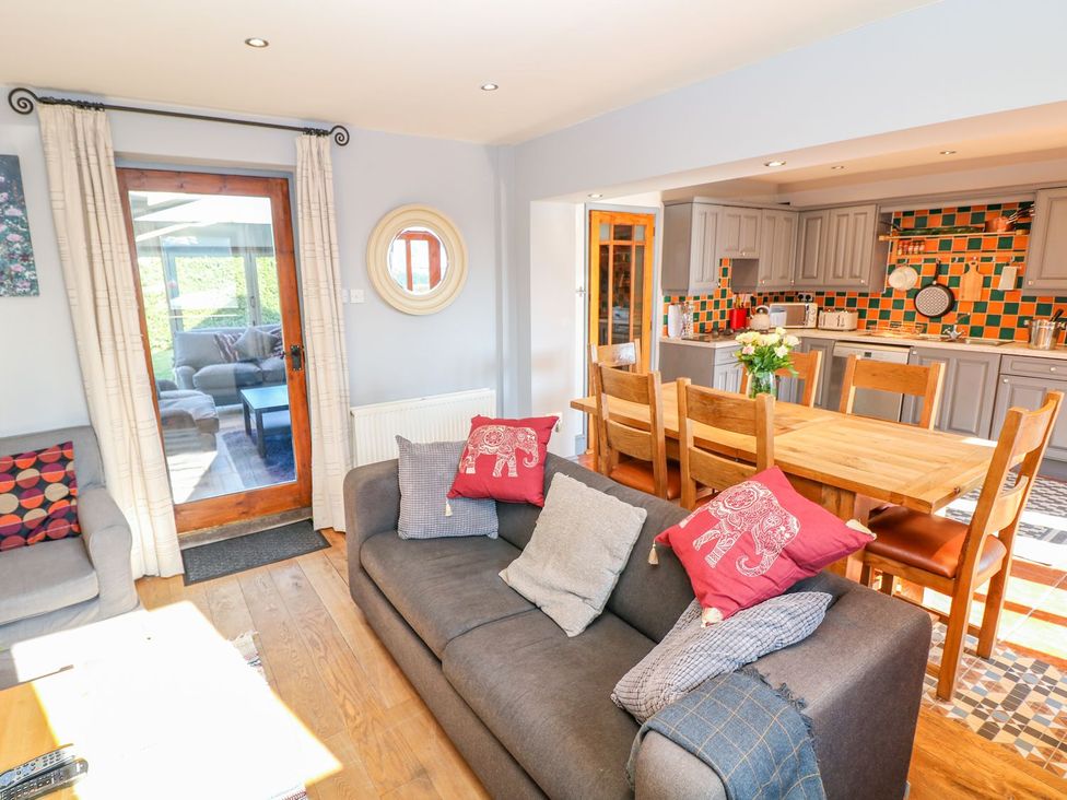 A living room with a sofa and dining area at Peters Lea in Bakewell