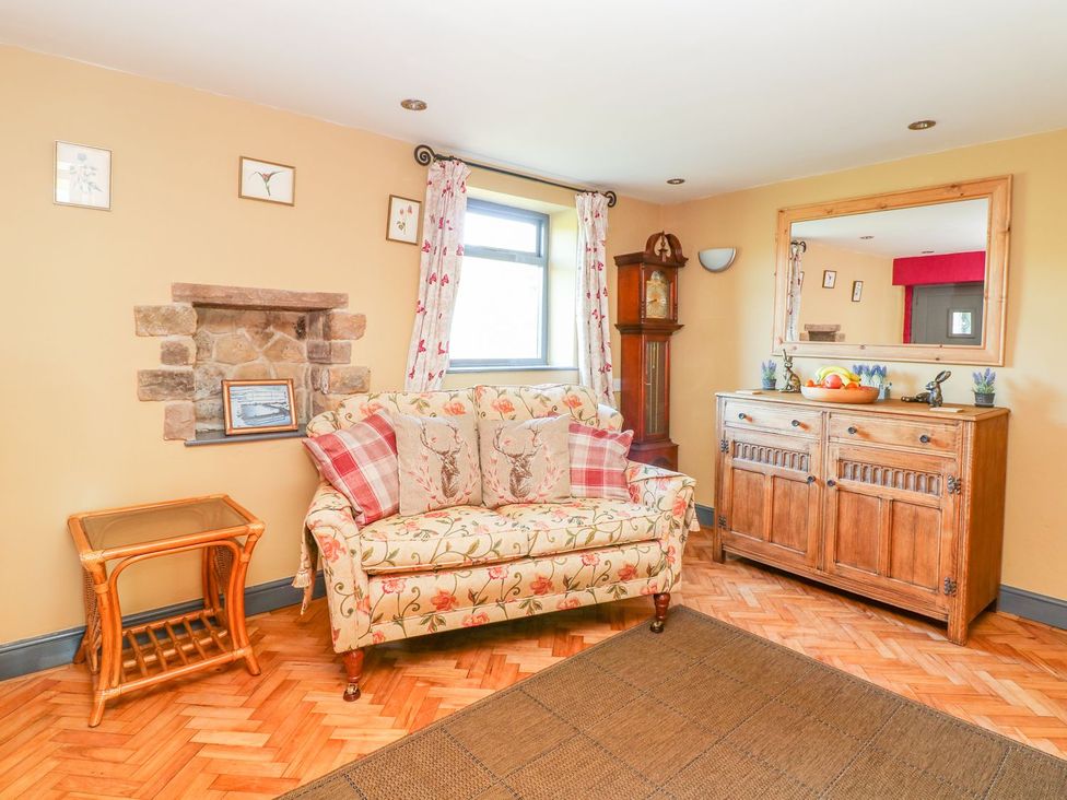 A living room with a sofa and side table at Peters Lea in Bakewell