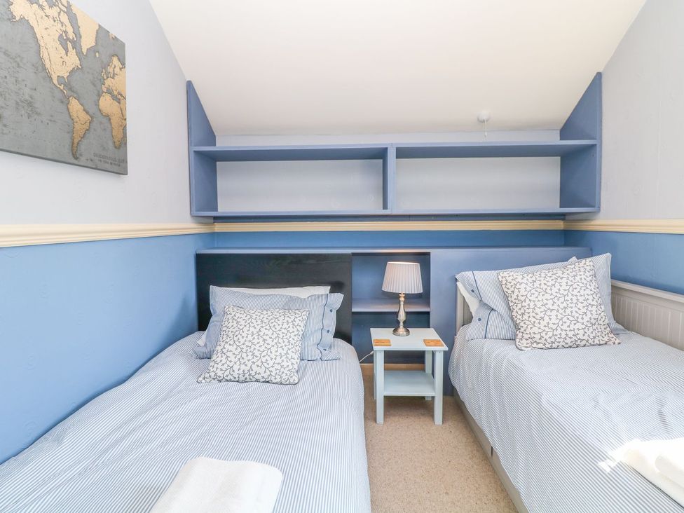 A bedroom with two beds and a map on the wall at Peters Lea in Bakewell