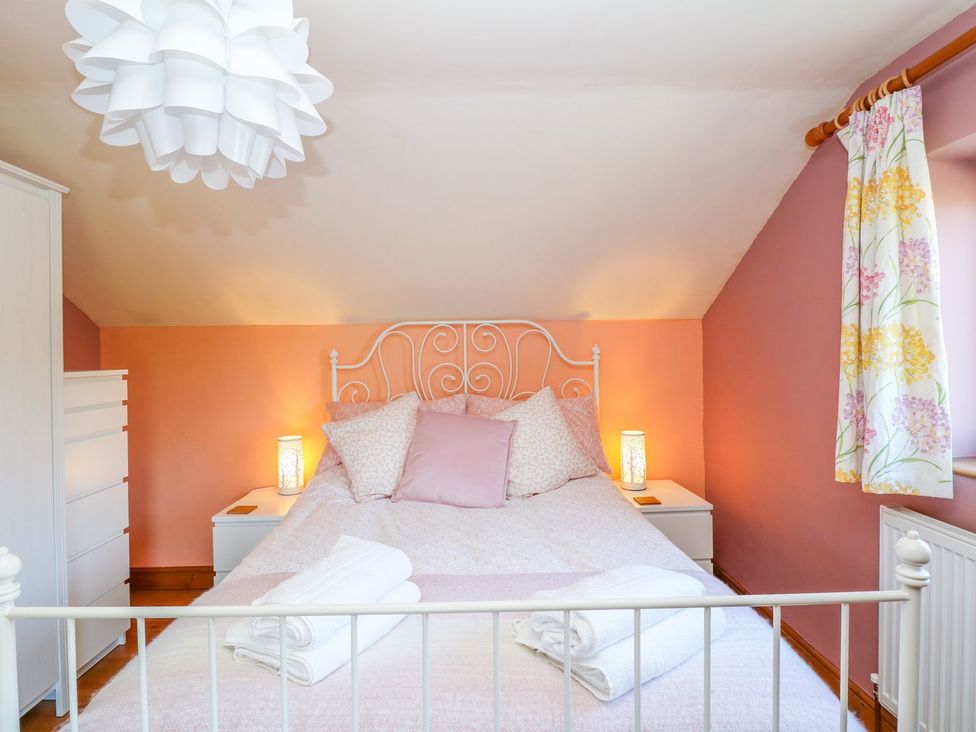 A bedroom with a bed and bedside table at Peters Lea in Bakewell