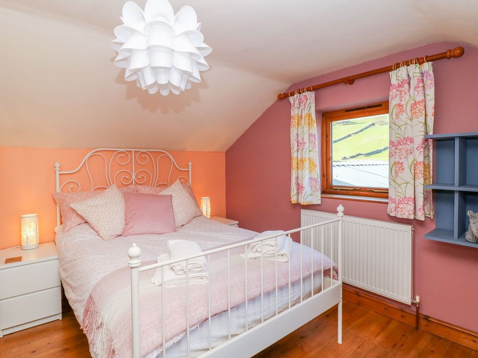 A bedroom with a bed and window at Peters Lea in Bakewell