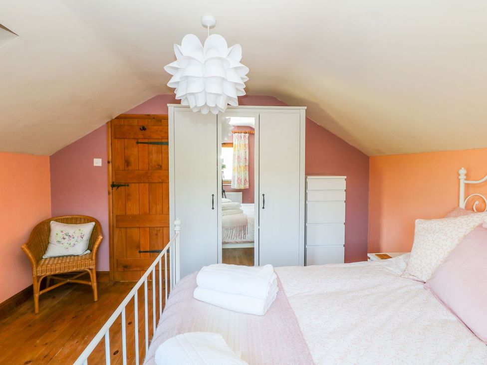 A bedroom with a bed and wardrobe at Peters Lea Bakewell