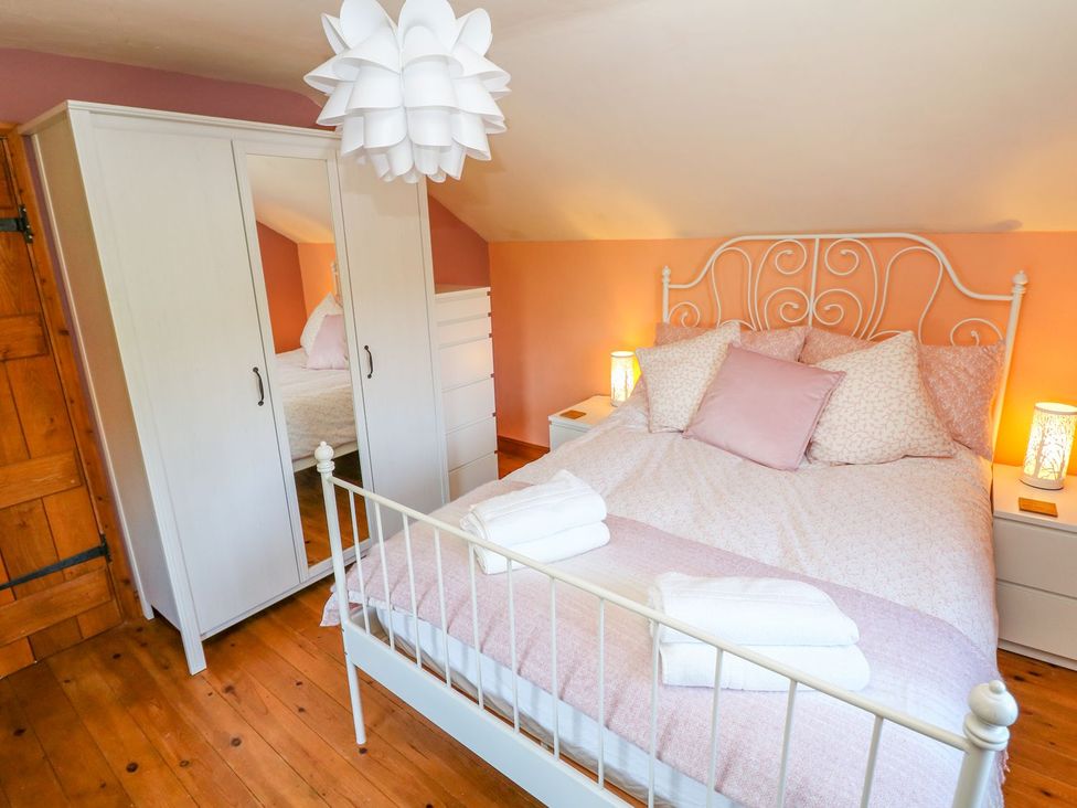 A bedroom with a bed and wardrobe at Peters Lea in Bakewell