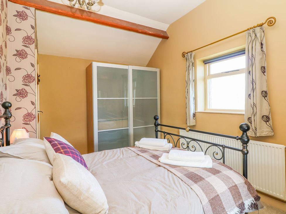 A bedroom with a bed and wardrobe at Peters Lea in Bakewell