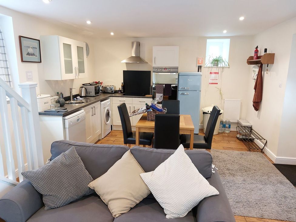 A kitchen with table and chairs at The Coach House- Canonbie in Canonbie near Langholm