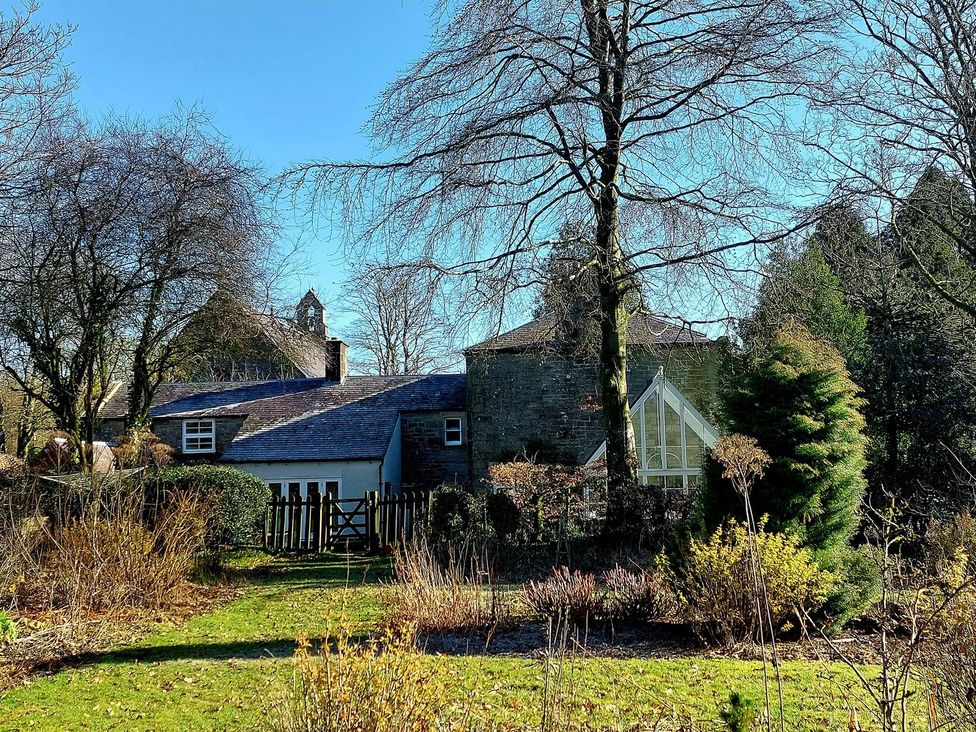 A house with a garden and trees at The Coach House- Canonbie in Canonbie near Langholm