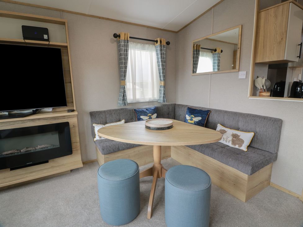 A living room with a sofa and table at Ellies House in Stranraer