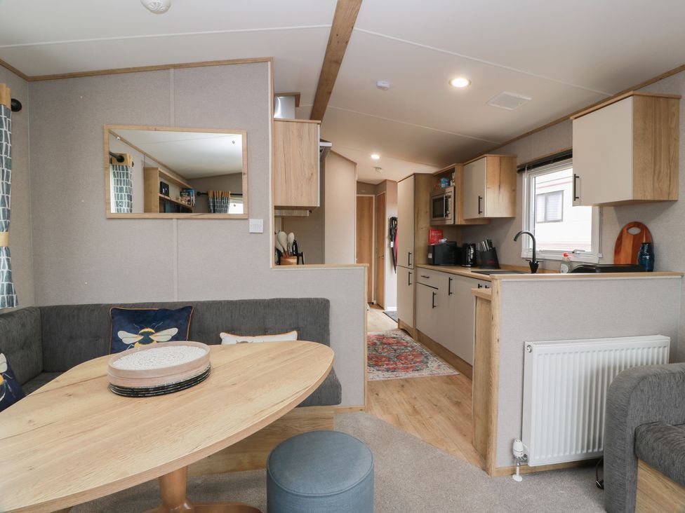A living room with a table and sofa at Ellies House in Stranraer