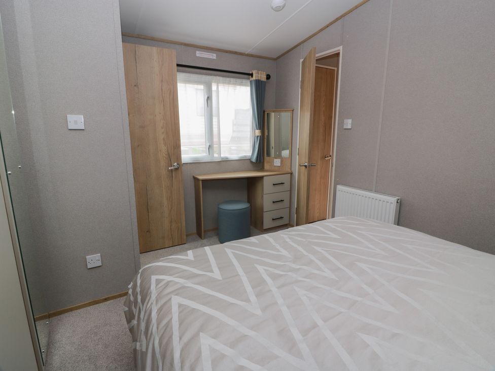 A bedroom with a bed and desk at Ellies House in Stranraer