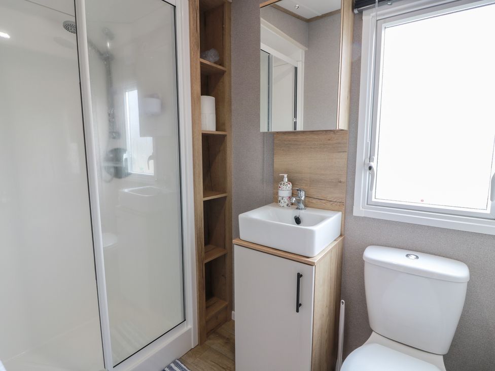 A bathroom featuring a shower, toilet, and sink at Ellies House in Stranraer