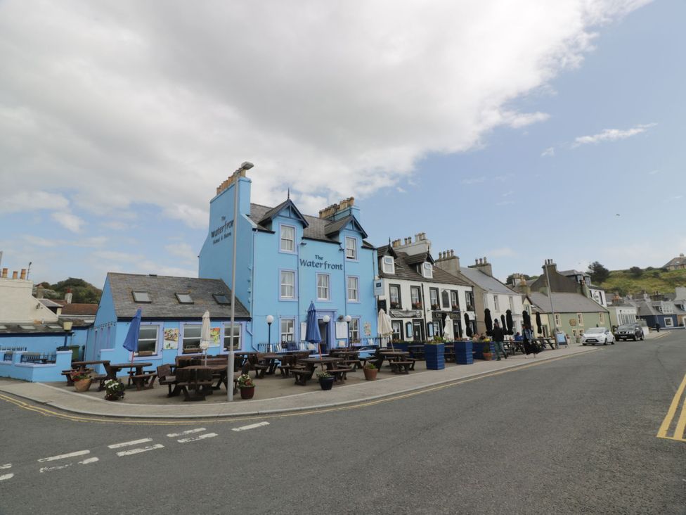 The exterior of The Waterfront pub with outdoor seating in Stranraer
