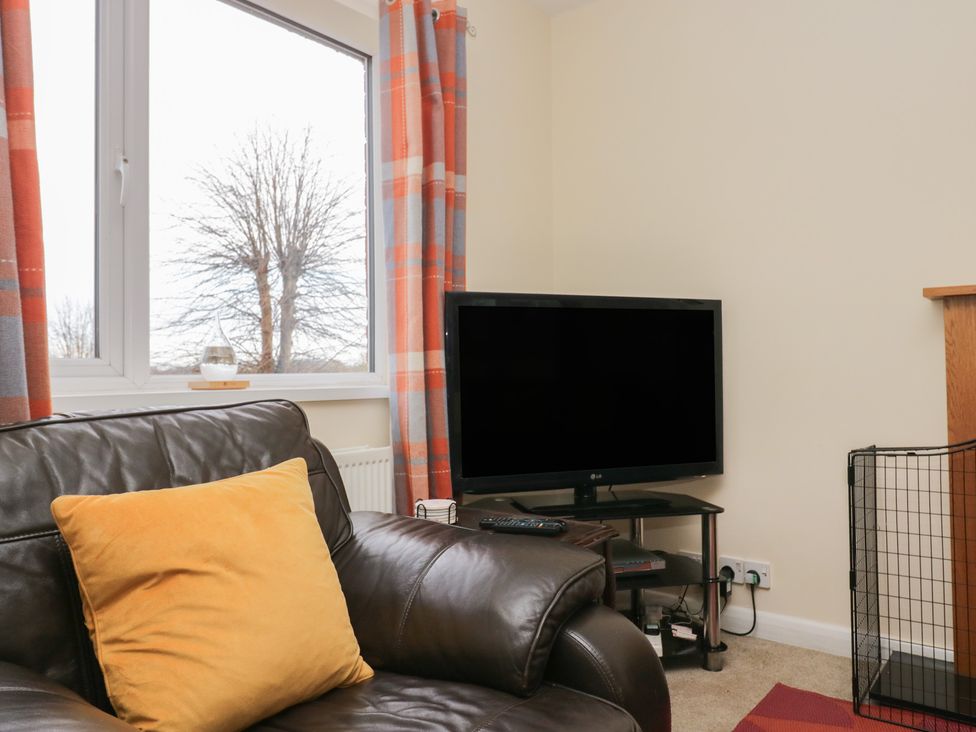 A living room with a couch and television at Castle Terrace in Penrith