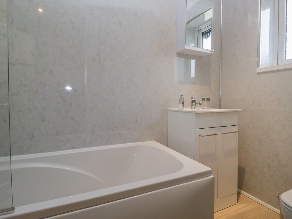 A bathroom with a bathtub and sink at Castle Terrace Penrith