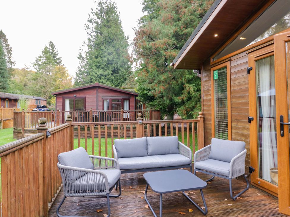 A seating area with a table and chairs at 5 Waterside Wood Troutbeck Bridge