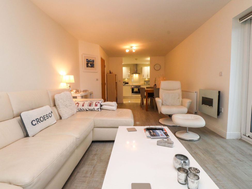 A living room with a sofa and coffee table at Heulfan in Conwy