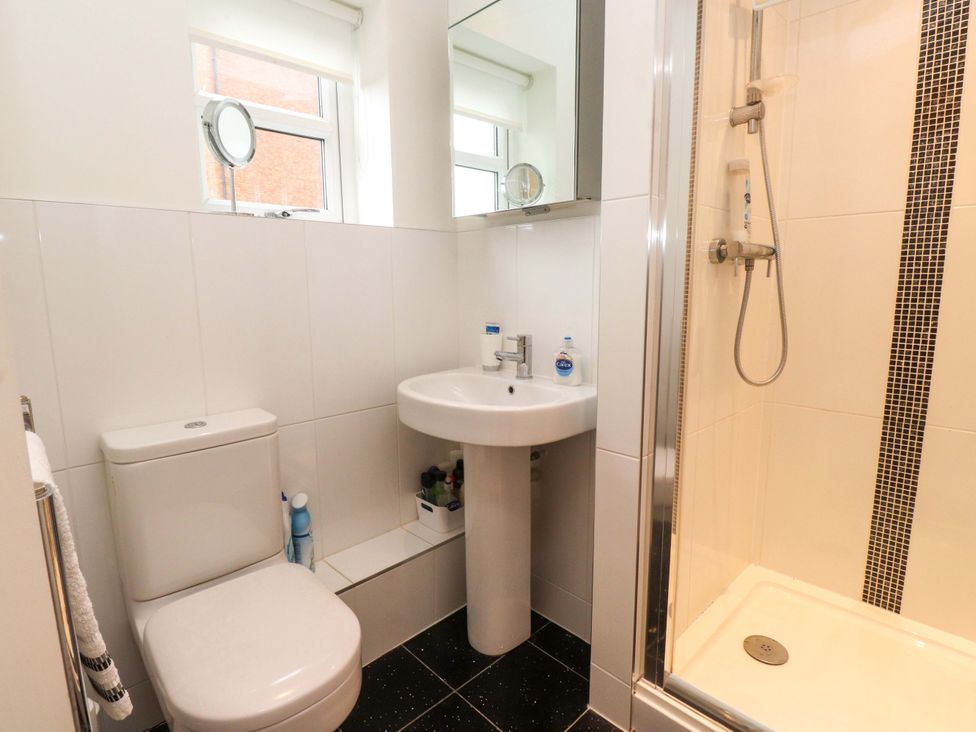 A bathroom with a shower and a sink at Heulfan in Conwy