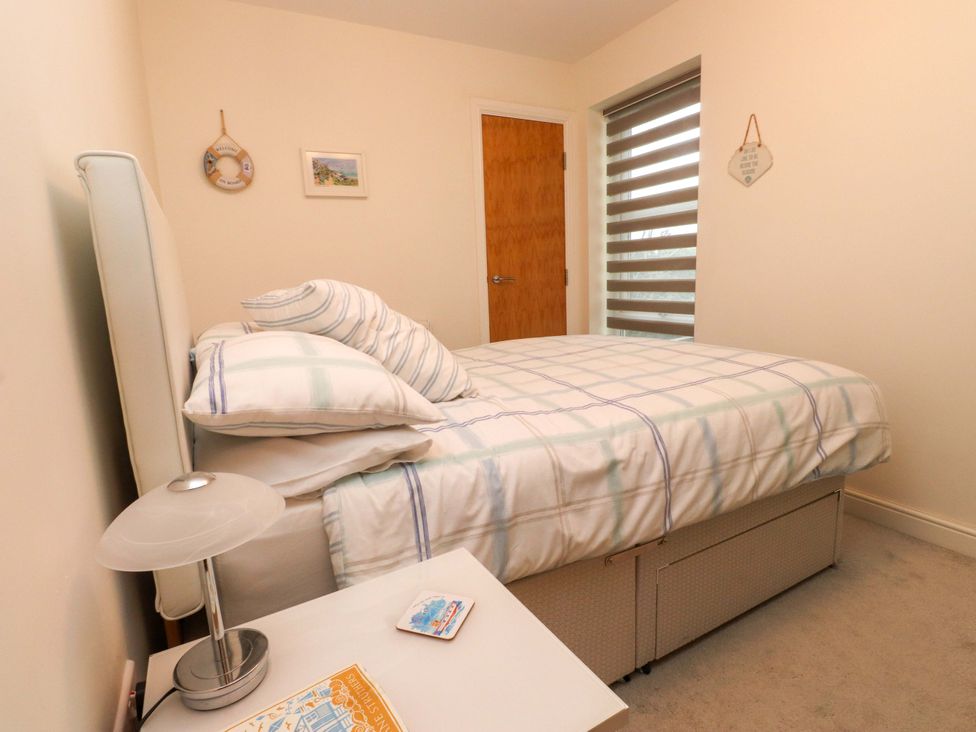A bedroom with a bed and bedside table at Heulfan in Conwy